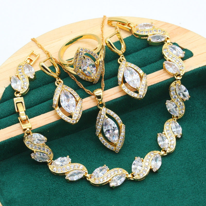 Luxury peridot jewelry set featuring gold chains, rings, earrings and bracelet with sparkling gemstones