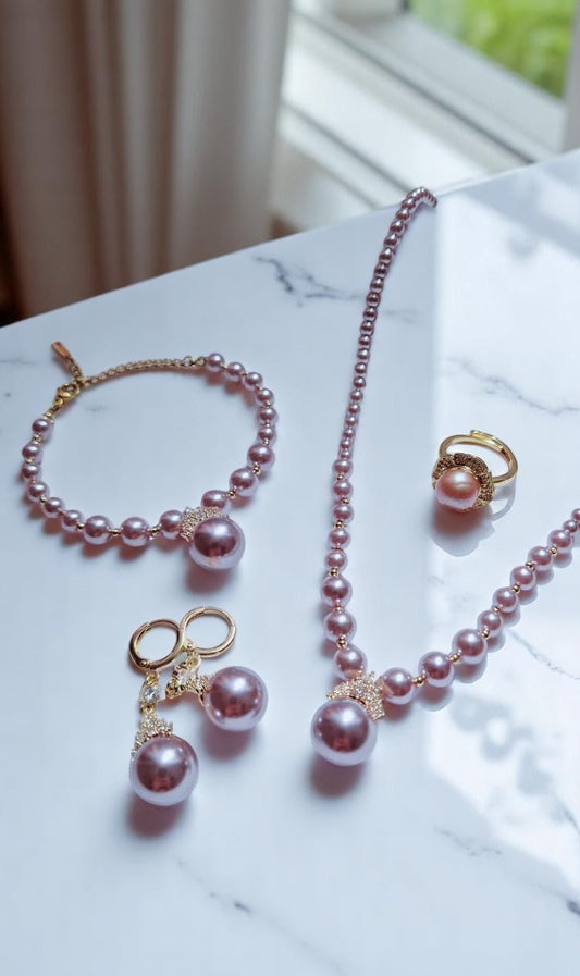 Luxury lavender jewelry set featuring pearl necklace, bracelet, earrings, and ring with gold accents