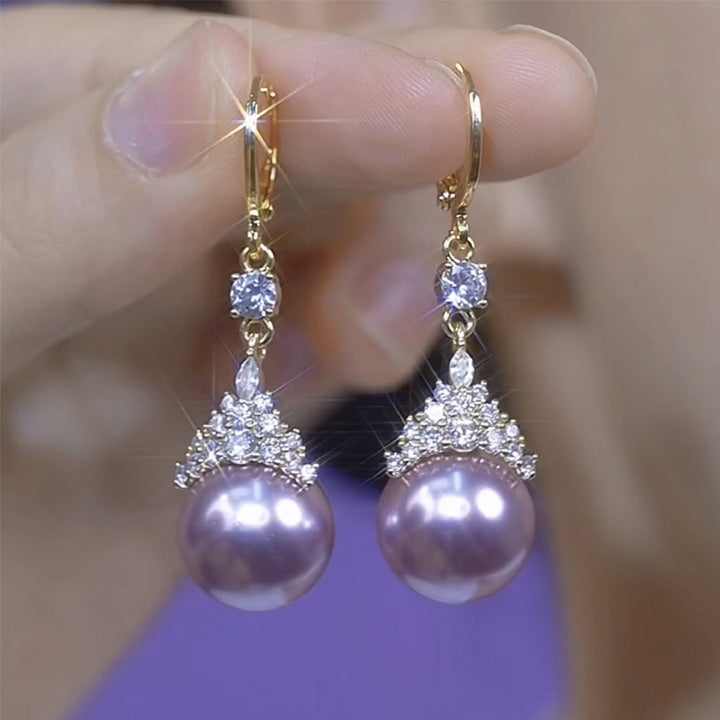 Luxury pearl jewelry set featuring gold earrings with large lavender pearls and sparkling clear crystals