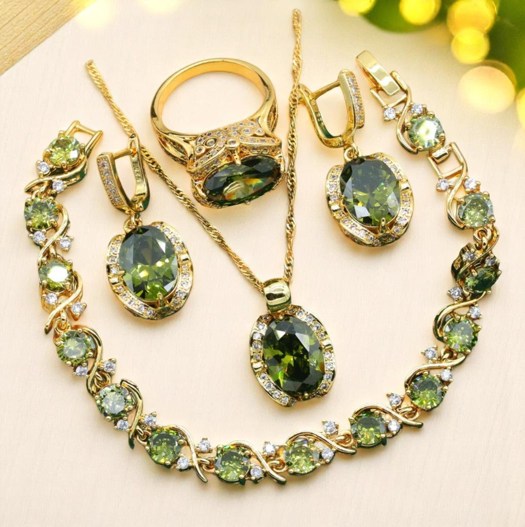 Luxury peridot jewelry set with gold ring, necklace, earrings, and bracelet featuring green peridot stones