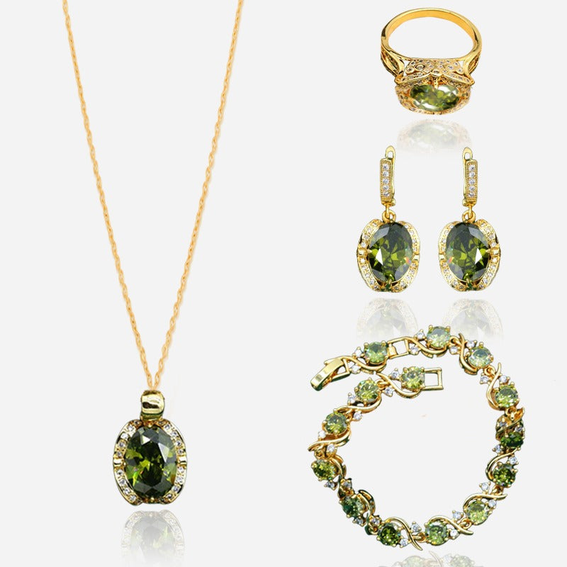 Luxury peridot jewelry set with gold ring, earrings, bracelet, and pendant necklace featuring green oval peridot stones