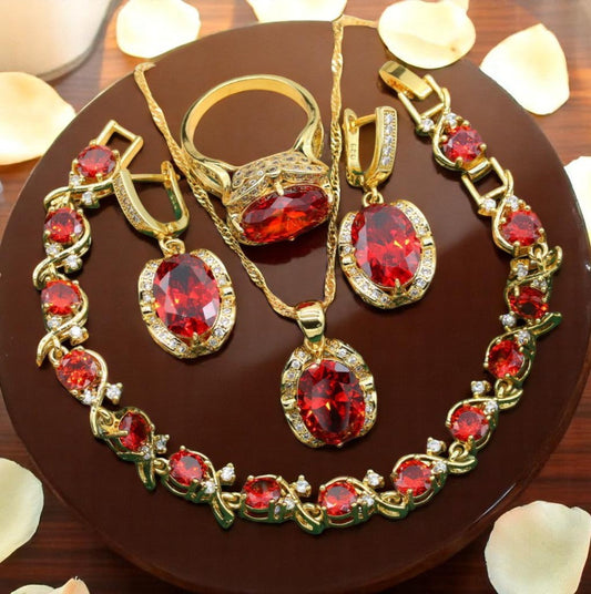 Luxury peridot jewelry set featuring gold chain necklace, ring, earrings, and bracelet with red gemstones